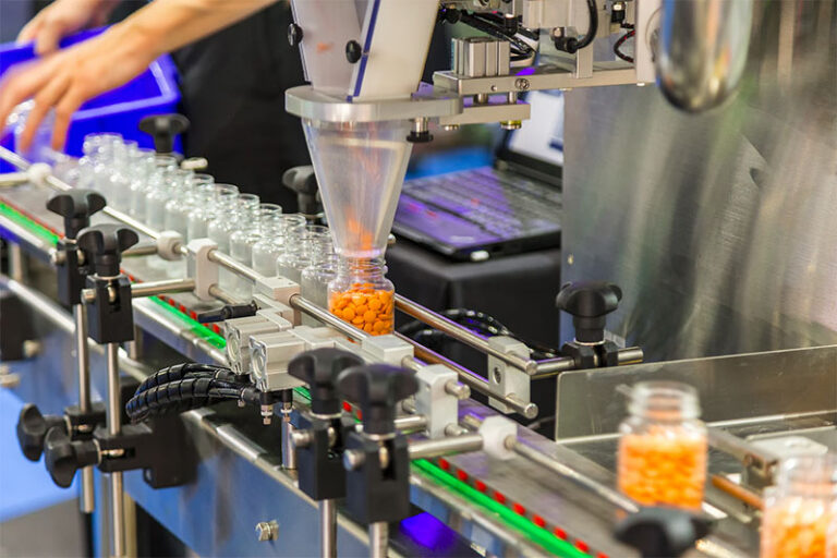Supplement manufacturing line filling bottles with pills