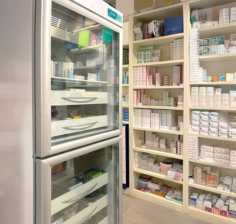 Refrigerated pharmaceutical storage unit stocked with boxed products